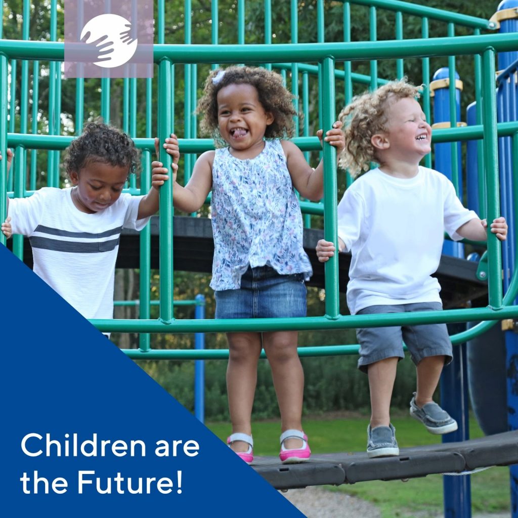 Three children playing on a play structure outside. 